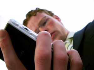 504653_businessman_looking_at_his_pda